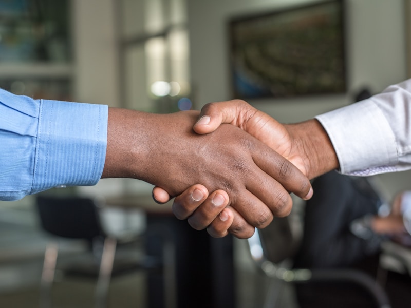 Professional handshake following a successful employment agreement discussion
